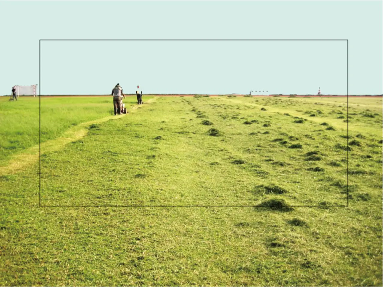 In this image there are three persons using grass cutters in the field, there is a goal post, a...