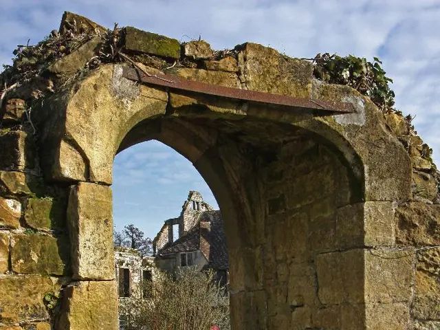 In the image there is a stone arch with steps below it and at the background there is a stone...