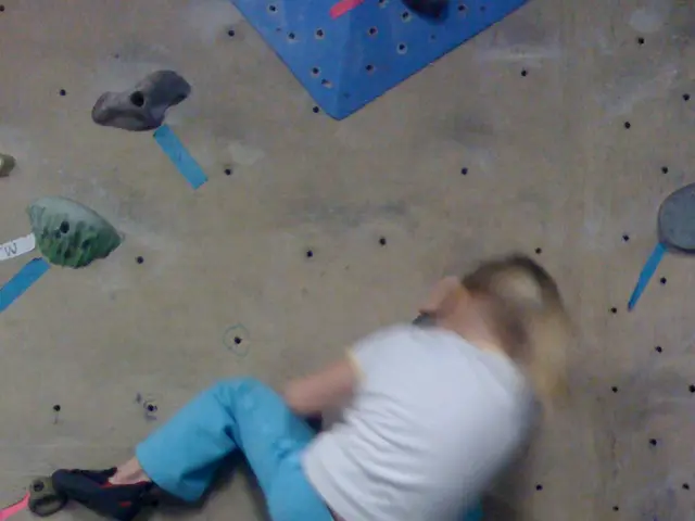 Here in this picture we can see a child performing bouldering over a place.
