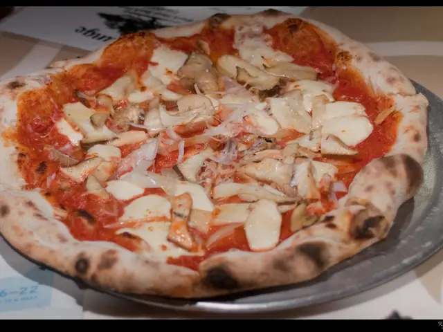 This image consists of a pizza along with stuffings are kept in a plate. The plate is on the table.